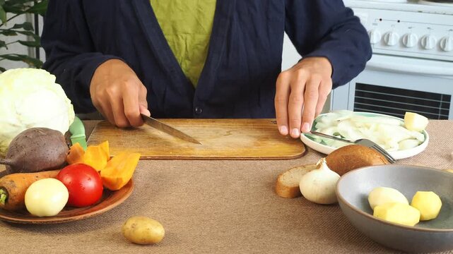 A man is preparing borscht with cabbage