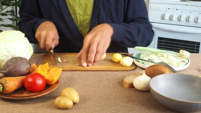 A man is preparing borscht with cabbage