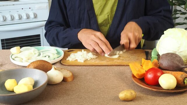 A man is preparing borscht with cabbage