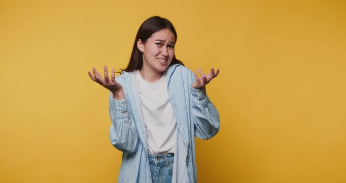 Feeling uncertain during a fun moment in a bright yellow room with a casual outfit