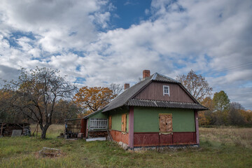 Obraz premium Old Rural Wooden House in Autumn Countryside