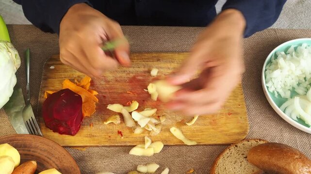 A man is preparing borscht with cabbage