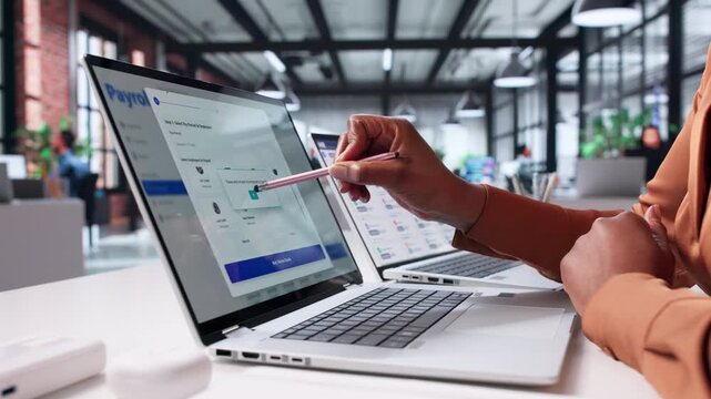 Woman Using Payroll App To Pay Salaries