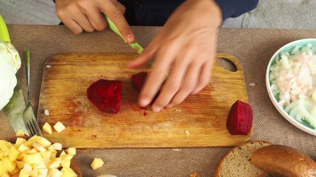A man is preparing borscht with cabbage