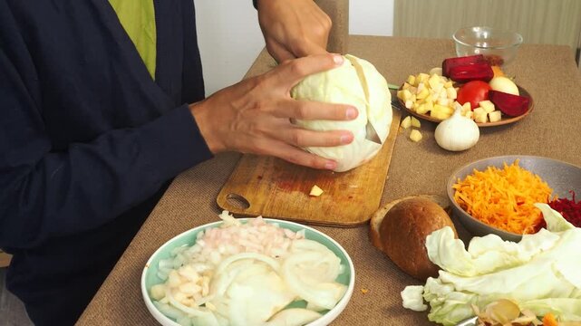 A man is preparing borscht with cabbage