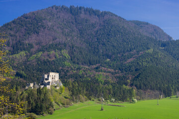 Likavka Castle ruins standing on rock overlooking rural landscape