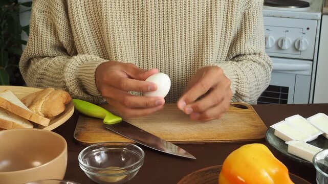 a man making egg sandwiches for breakfast