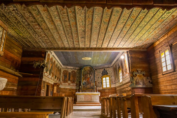 Traditional wooden church interior with ornate painted ceiling in Zuberec, Slovakia
