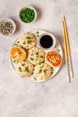 Delicious buns served on a plate with sauces and toppings