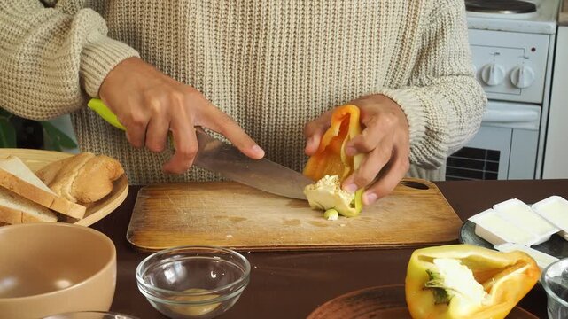 a man making egg sandwiches for breakfast