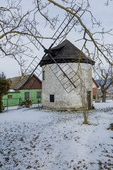 Historic windmill with wooden sails in snowy Zlin, Czechia