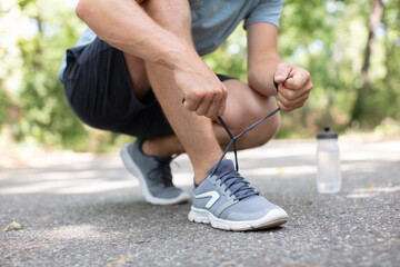 running shoes - closeup of man tying shoe laces