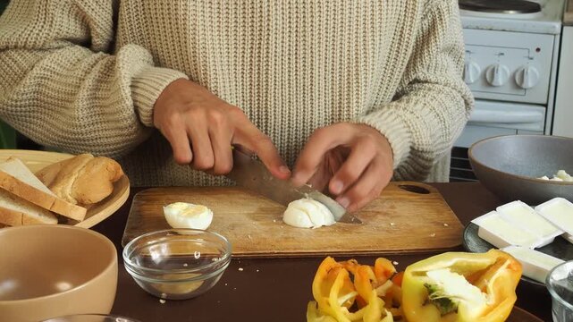 a man making egg sandwiches for breakfast