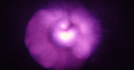 A vibrant purple light effect with a soft, diffused appearance, creating an abstract and mysterious atmosphere.