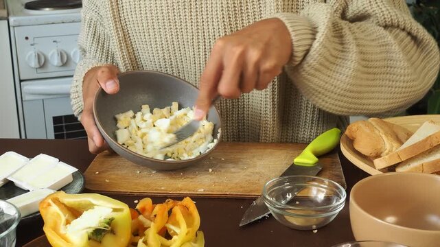 a man making egg sandwiches for breakfast