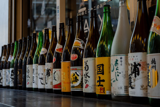 Shibuya, Tokyo 18 - 03 - 2025: Big empty sake bottles outside a bar in Japan
