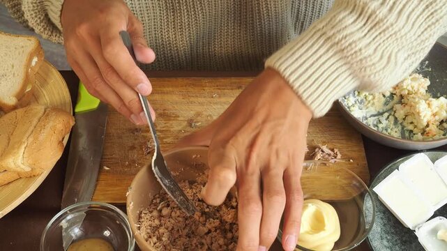 a man making egg sandwiches for breakfast