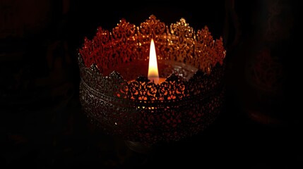 A single candle flickers in the darkness, surrounded by a mysterious, glowing, red, crystalline structure.