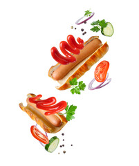 Cut open sausages in pastry with ketchup and vegetables close-up isolated on a white background