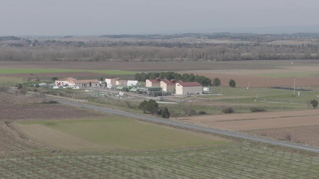 Aerial side-way view of a natural gas compressor station and energy infrastructure in France
