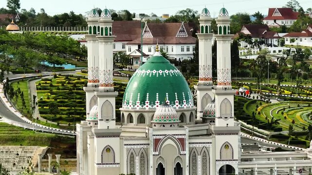 Aerial view of beautiful mosque in the background of the mountains. Masjid Agung Syahrun Nur Tapanuli Selatan. Indonesia.