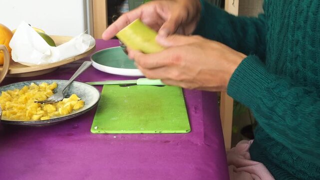 a man preparing a fruit dessert