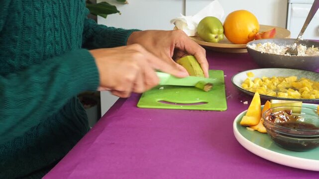 a man preparing a fruit dessert