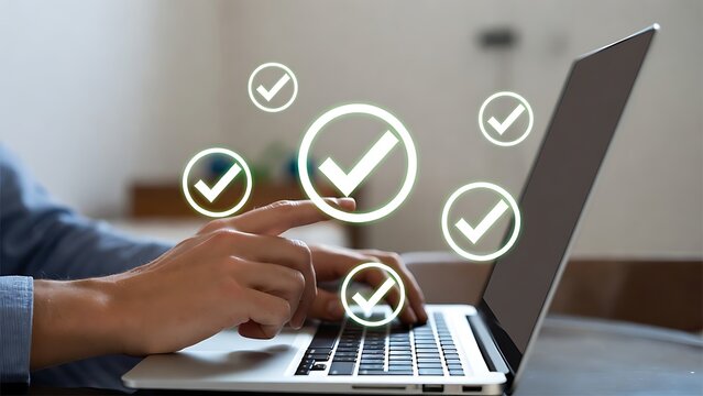 Man typing on laptop in office working on laptop with holographic chekmark