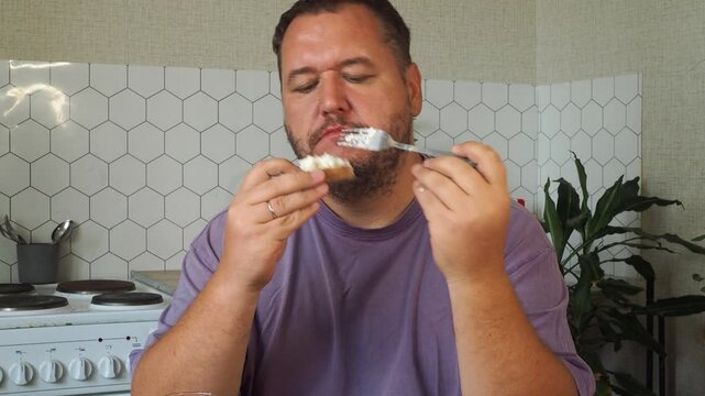 a grown man is having lunch in the kitchen