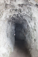 Rough stone tunnel or cave passage carved in rock
