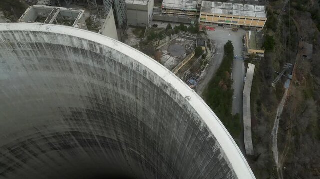 Flyng over edge of abandoned power plant smoke stack 4k drone
