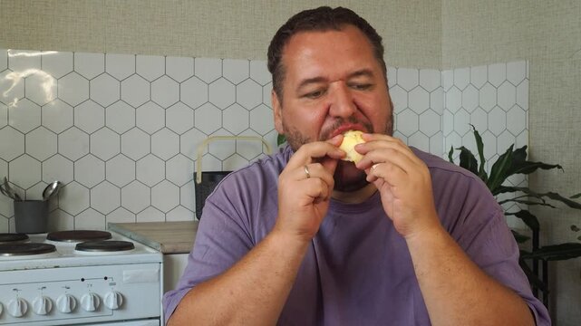 a grown man is having lunch in the kitchen