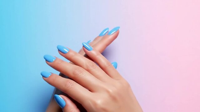 Two hands with light blue manicured nails are clasped together against a gradient backdrop