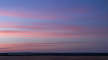 Fototapeta premium Serene sunset casting warm glows over the horizon