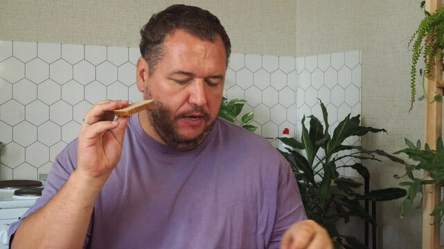 a grown man is having lunch in the kitchen