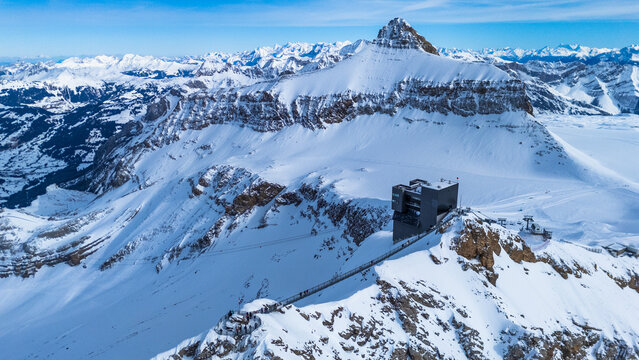 Winter photo of Glacier 3000 in Switzerland, showcasing snow-covered peaks, icy glaciers, and dramatic alpine scenery under a clear mountain sky