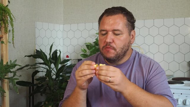 a grown man is having lunch in the kitchen