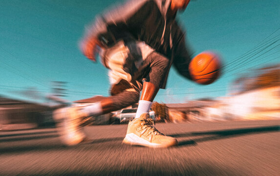 Man playing basketball on outdoor street court with motion blur and noisy effect. 
