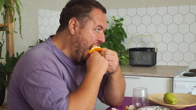 a grown man is having lunch in the kitchen