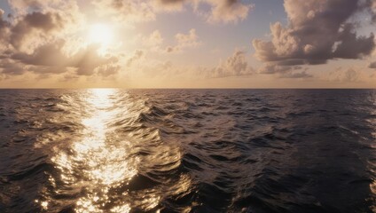 Obraz premium Golden Sunset Over Calm Ocean Waves Reflecting Sunlight.