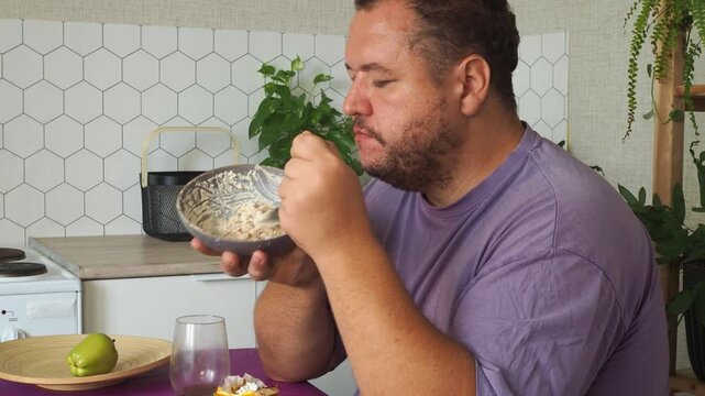 a grown man is having lunch in the kitchen