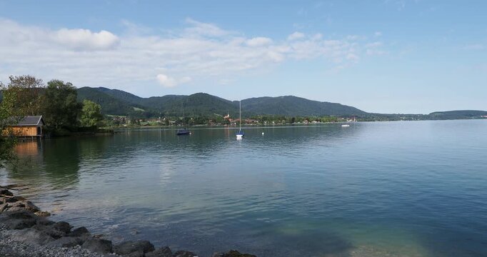 Landscape in Bavarian Alps - View of the calm waters of Lake Tegernsee with its marina, Ringsee and Bad Wiesseede from the Rottach-Egern lake promenade

