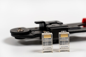 RJ45 connectors on a white background close-up. Modular plug crimper for RJ-45 on white background