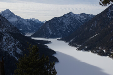 Frozen Plansee lake in Austrian Alps, winter mountain landscape in Tyrol
