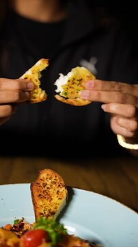 tearing a fried spicy bread