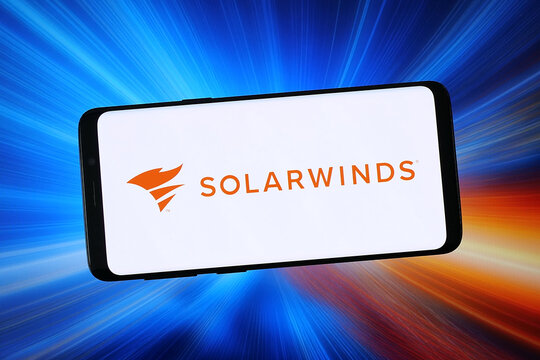 Stuttgart, Germany - 02-04-2026: In this photo illustration, the logo of network monitoring company SolarWinds Corp. is displayed on a smartphone in front of abstract background on computer screen.