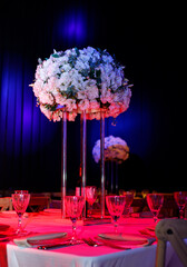 Elegant decoration of a ceremonial hall . Refined floral arrangements, dramatic lighting,
