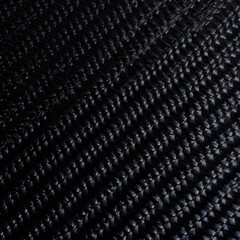 Abstract black wicker background with elegant braided texture and glossy dark material showing intricate interlocking geometric pattern for luxury modern design concepts