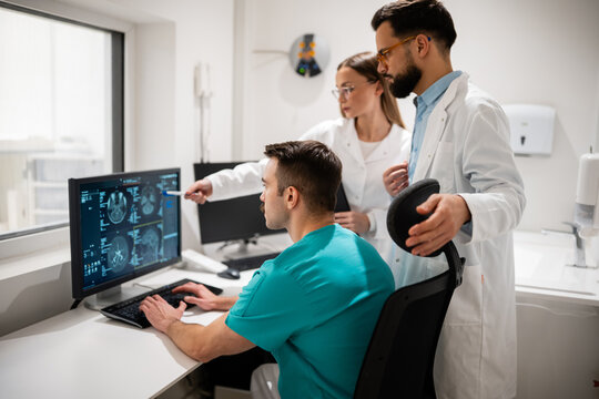Medical team collaborating analysing brain mri scans