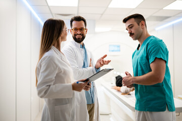 Medical team collaborating in mri scanning room